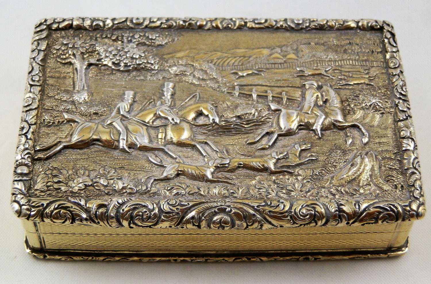 A George IV hunting scene silver gilt table snuff box, 1829