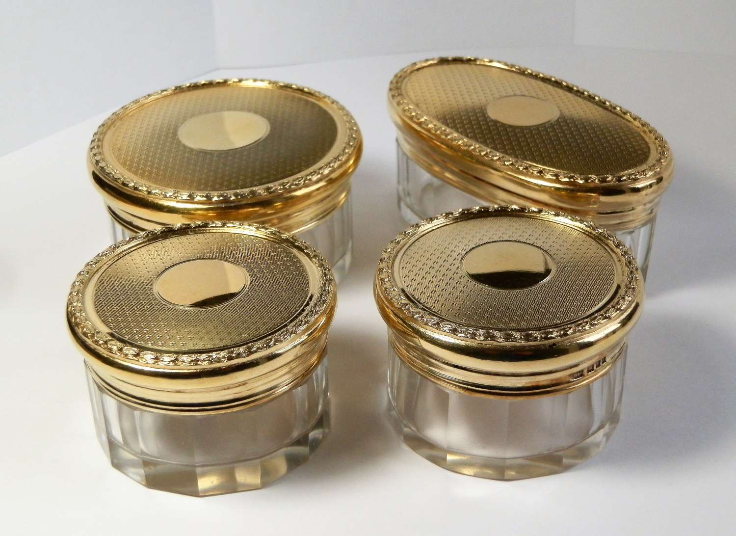 Set of 4 silver gilt dressing table jars, London 1929