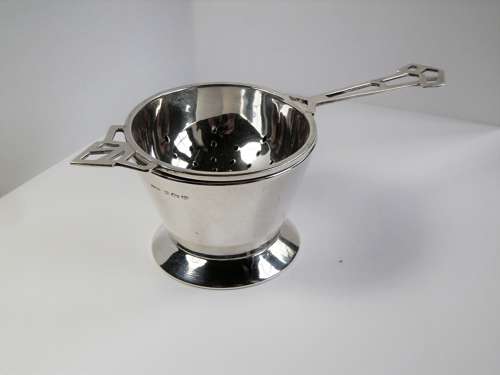 An Art Deco silver 2 piece tea strainer, Birmingham 1944