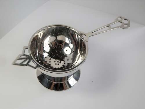 An Art Deco silver 2 piece tea strainer, Birmingham 1944