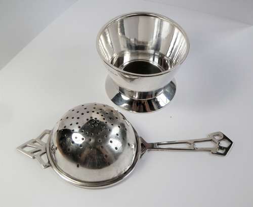 An Art Deco silver 2 piece tea strainer, Birmingham 1944