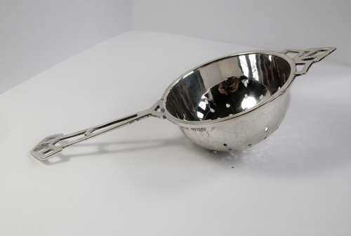 An Art Deco silver 2 piece tea strainer, Birmingham 1944