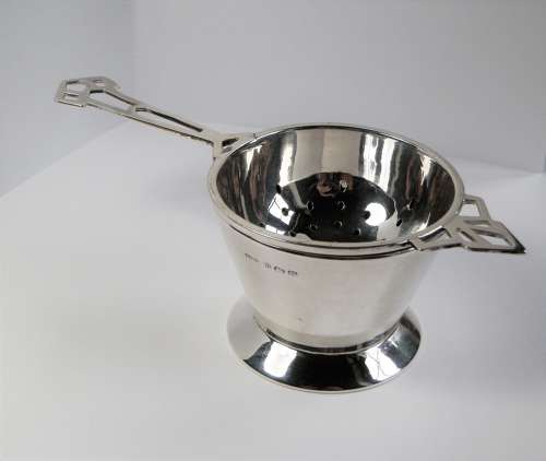 An Art Deco silver 2 piece tea strainer, Birmingham 1944