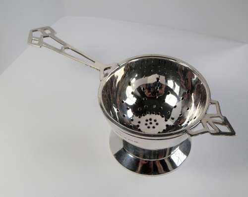 An Art Deco silver 2 piece tea strainer, Birmingham 1944