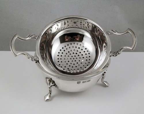 Elizabeth II silver two piece tea strainer, Birmingham 1962